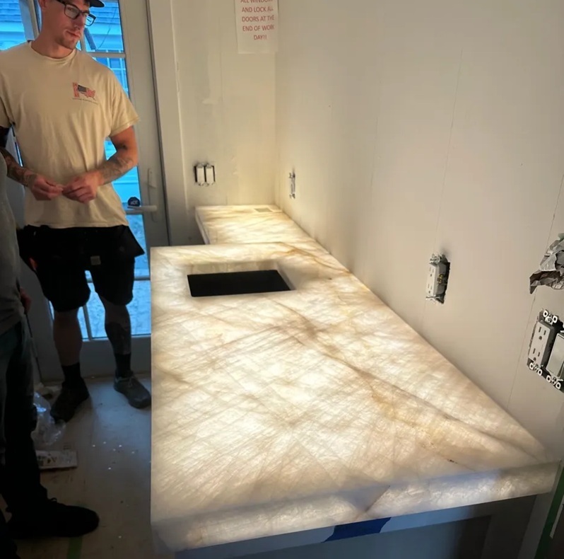 Backlit Cristallo Quartzite perimeter countertop with sink cutout during installation in Massachusetts