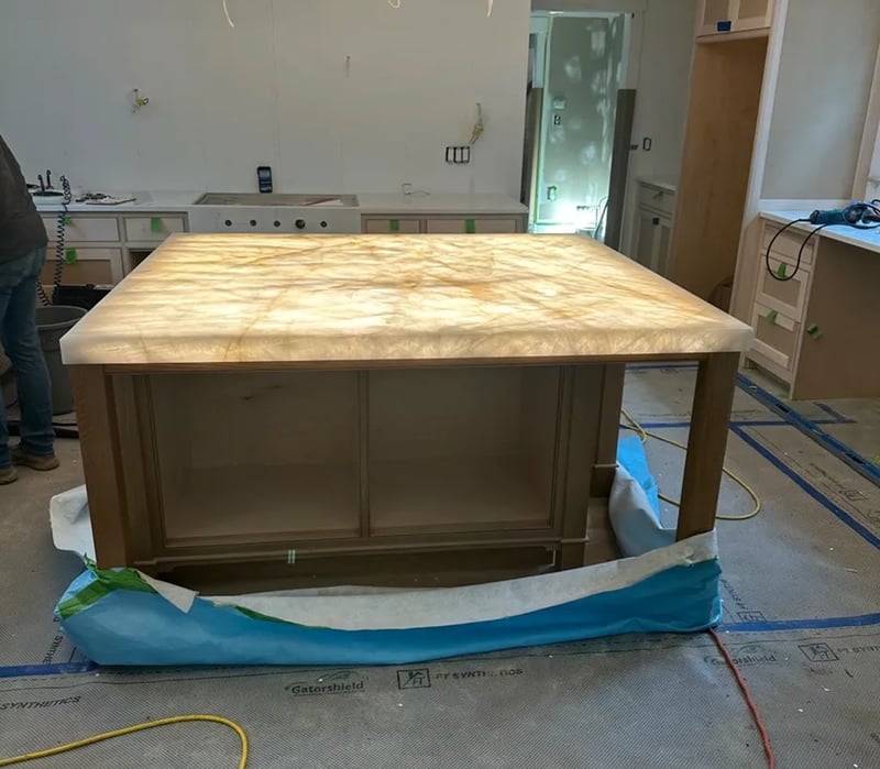  cristallo-quartzite-island-installation-backlit-glow.jpg Alt text: Cristallo Quartzite island glowing during installation with LED backlighting in Massachusetts kitchen