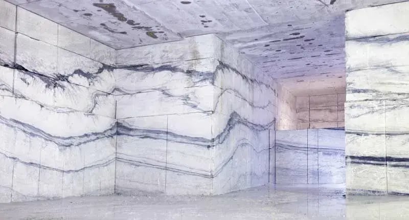 Underground chamber inside Danby marble quarry in Vermont showing dramatic gray veining patterns carved into the white marble walls