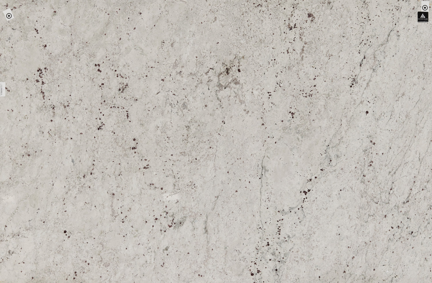 Balthus garanite countertops with soft white tones and subtle burgundy speckles, ideal for kitchen countertops, vanities, and fireplaces by Granite Guy Inc.