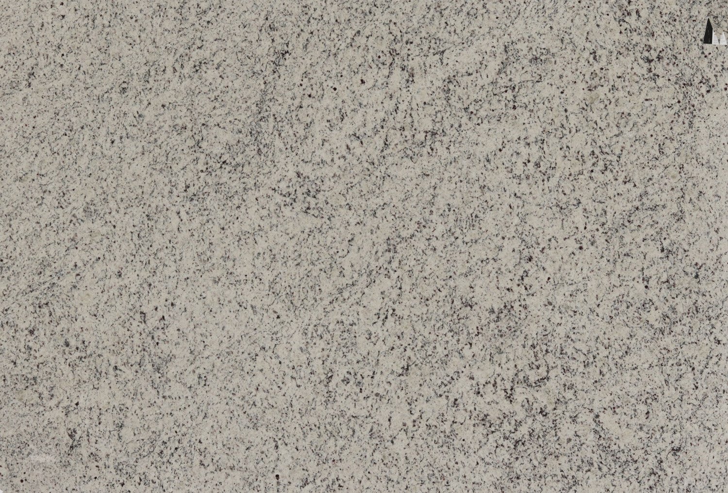 Bianco Leblon granite countertops with soft white and gray speckled pattern, ideal for kitchen countertops, vanities, and fireplaces by Granite Guy Inc.