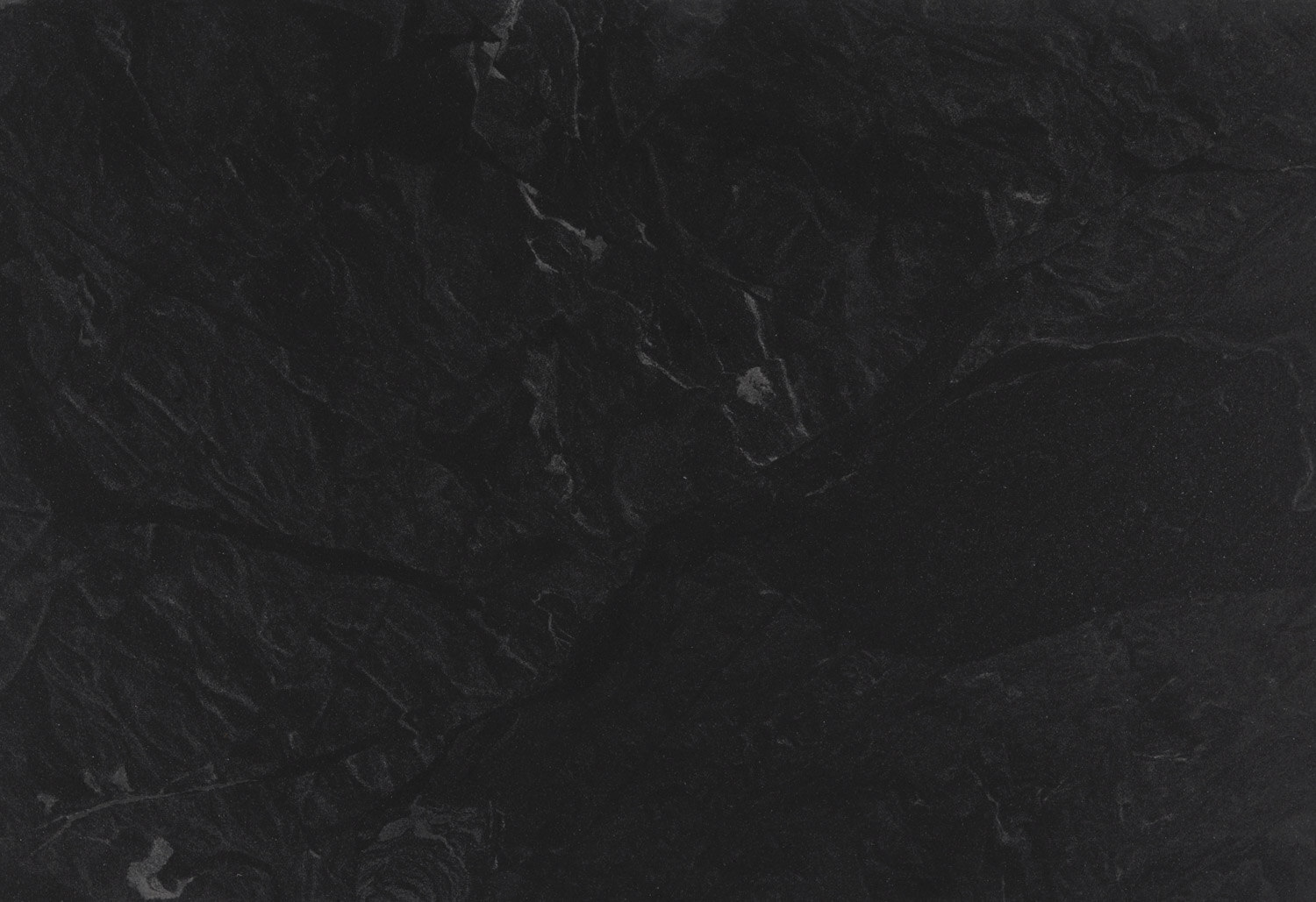 Jet Mist granite countertops with a deep black base and subtle misty patterns, perfect for kitchen countertops by Granite Guy Inc.