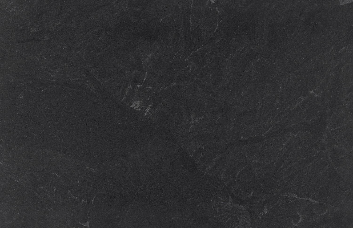 Jet Mist Honed granite countertops with a sleek black surface and soft veining, perfect for kitchen countertops by Granite Guy Inc.