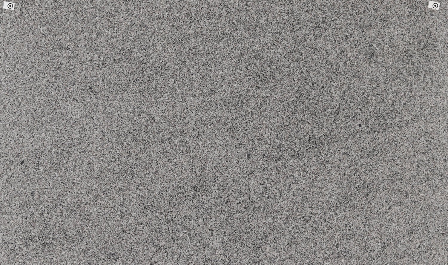 New Caledonia granite countertops with fine gray and black speckled patterns, perfect for kitchen countertops and fireplaces by Granite Guy Inc.