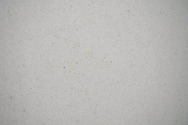 Limestone Caliza Capri countertops in a soft off-white tone with fine speckled texture, great for kitchen countertops. Limestone by Granite Guy Inc.
