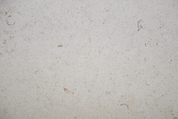Limestone Cannes countertops in a light beige tone with scattered shell fossils, great for kitchen countertops. Limestone by Granite Guy Inc.