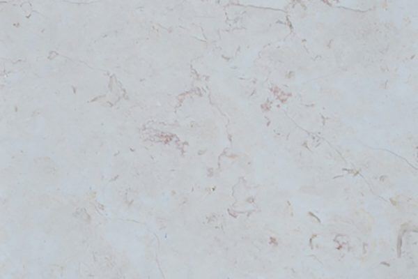 Limestone Hebron Bone countertops in a pale beige tone with soft pink veining, great for kitchen countertops. Limestone by Granite Guy Inc.