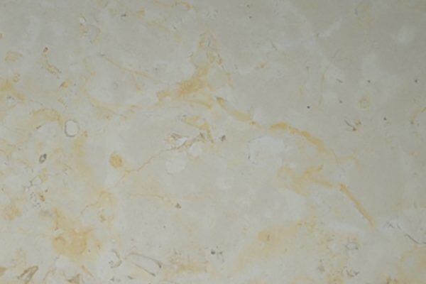 Limestone Saint Croix Honed countertops in a warm beige tone with golden fossil veining, great for kitchen countertops. Limestone by Granite Guy Inc.