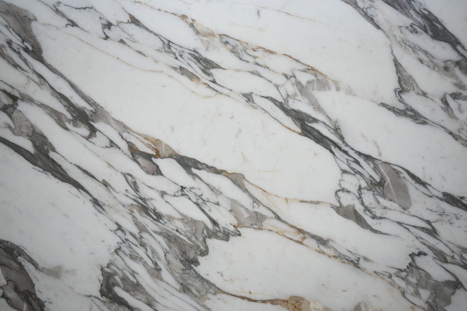 Calacatta Borghini marble countertops with bold gray veining and gold accents, perfect for kitchen countertops and vanities by Granite Guy Inc.