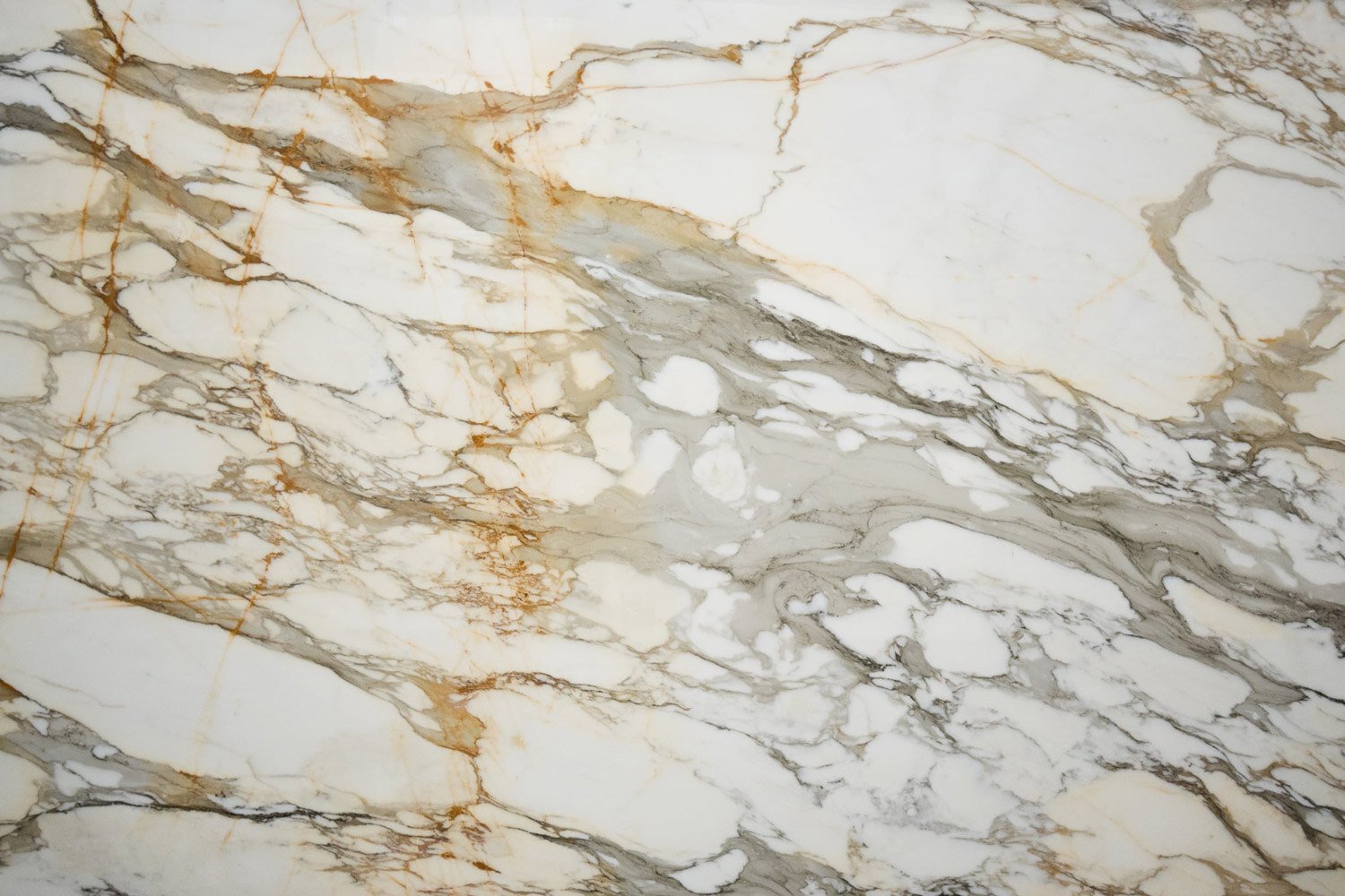 Calacatta Gold marble countertops with bold gold and gray patterns, perfect for kitchen countertops and bar tops by Granite Guy Inc.