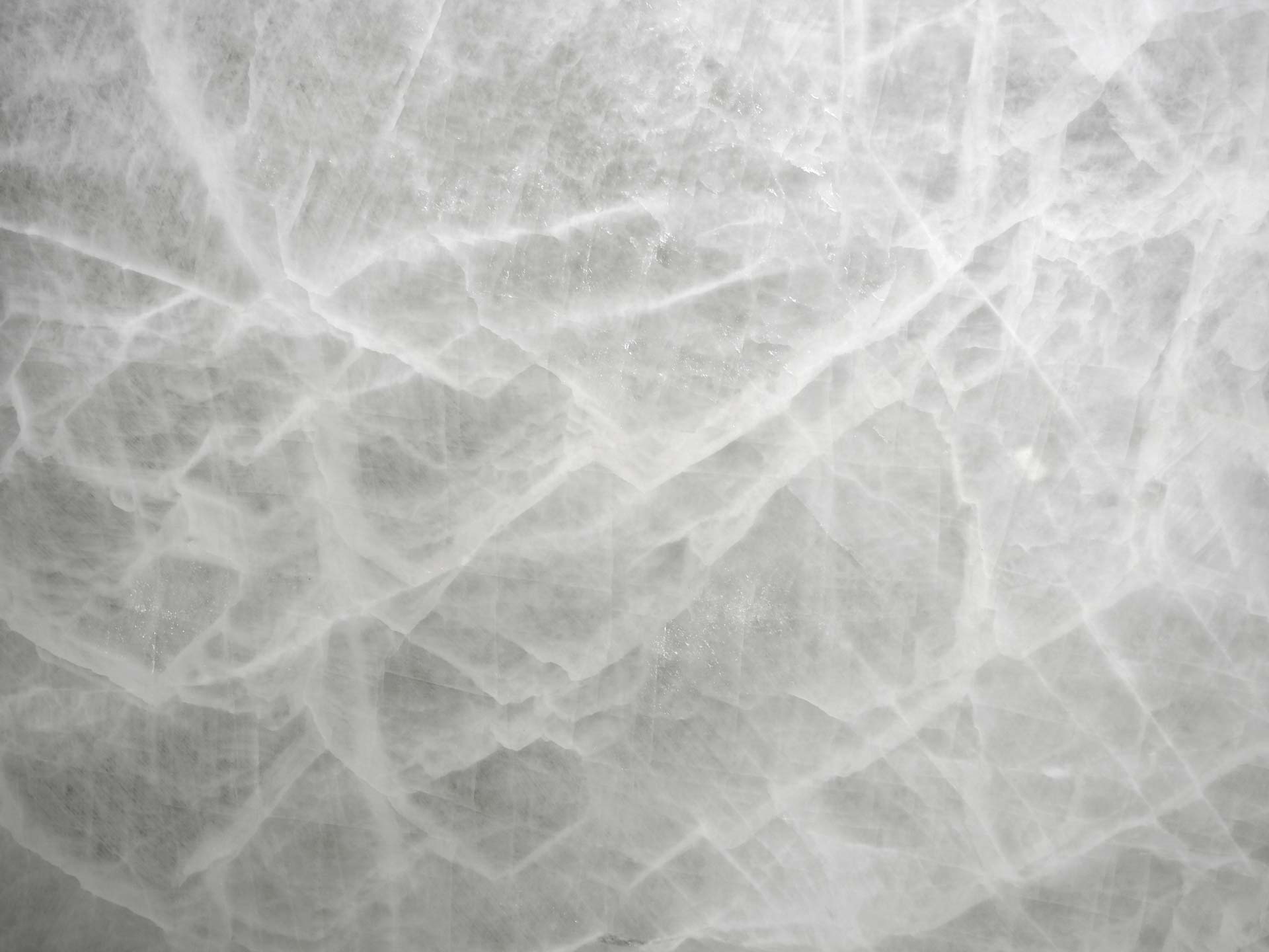 Onyx Alba Pura White Glass countertops with icy translucent texture for kitchen countertops. Onyx by Granite Guy Inc.