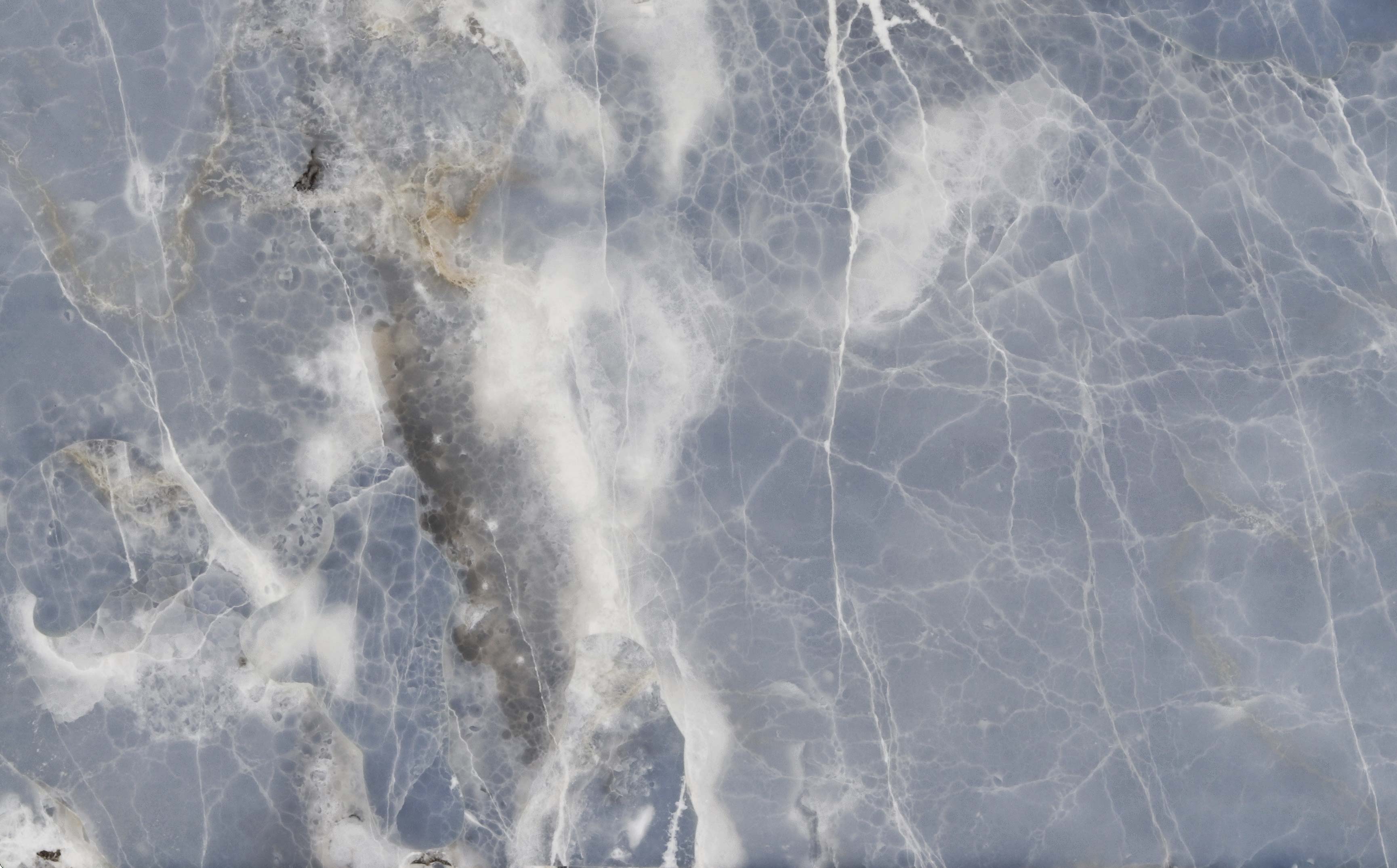 Onyx Blue countertops with soft blue base and white crystalline veins for kitchen countertops. Onyx by Granite Guy Inc.