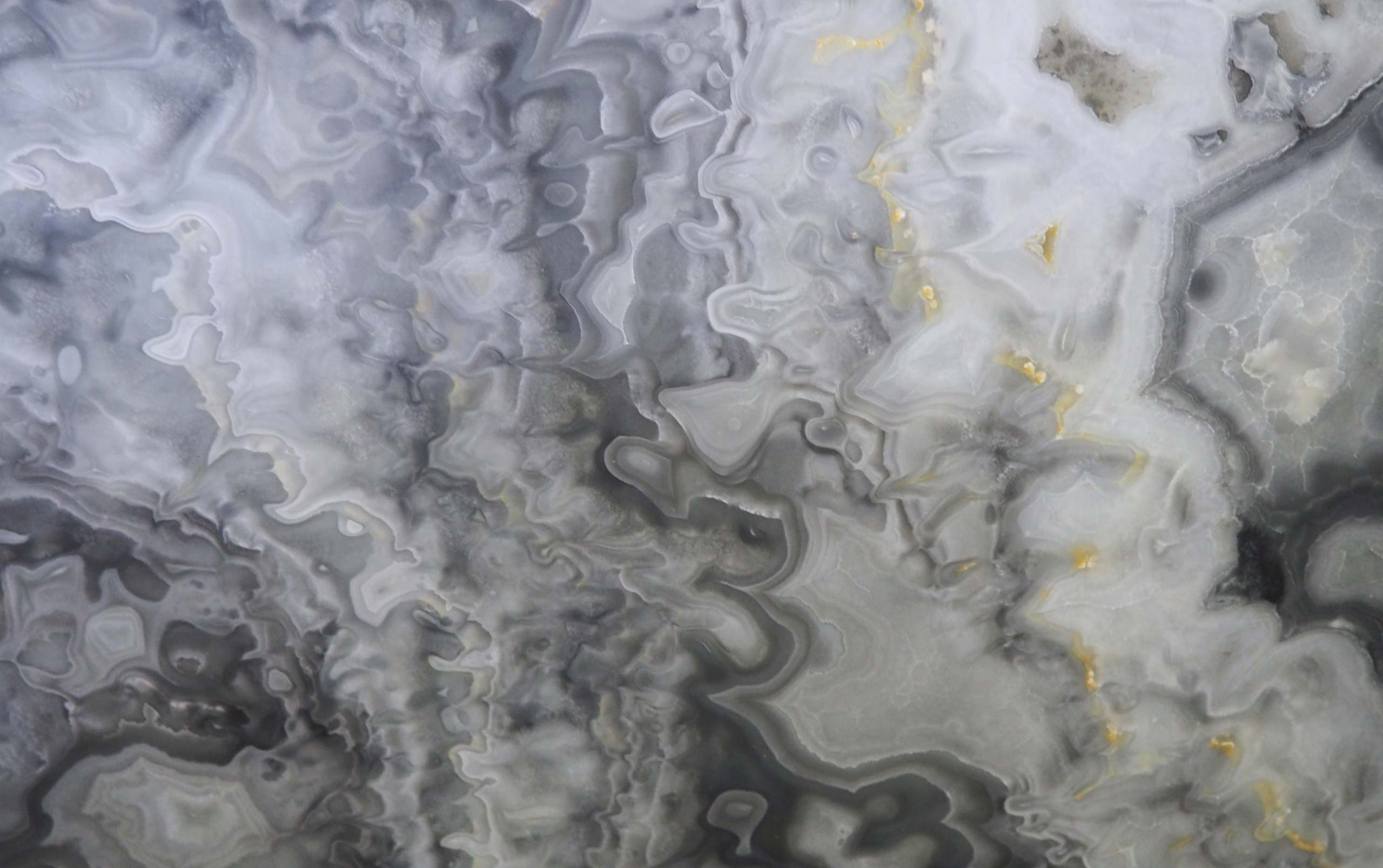 Onyx Glacier Blue countertops with swirling gray, white, and gold accents for kitchen countertops. Onyx by Granite Guy Inc.