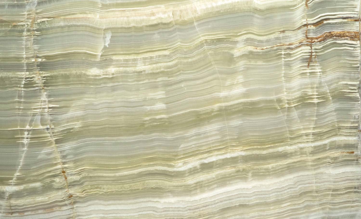 Onyx Green Vein Cut countertops with layered sage tones and soft golden banding for kitchen countertops. Onyx by Granite Guy Inc.