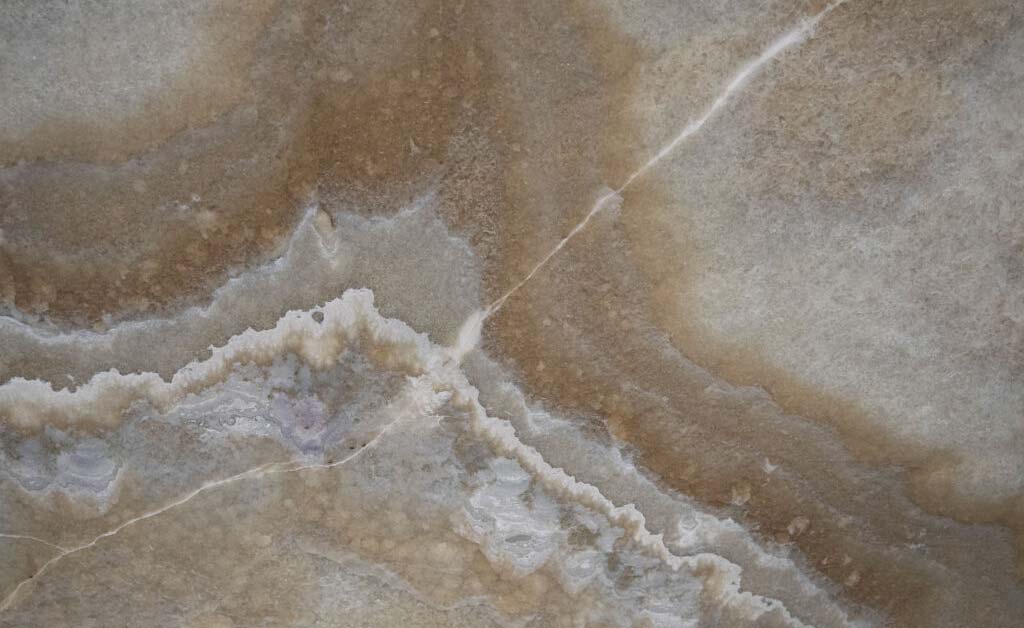Onyx Grey Smoke countertops with swirling taupe and grey layers for kitchen countertops. Onyx by Granite Guy Inc.