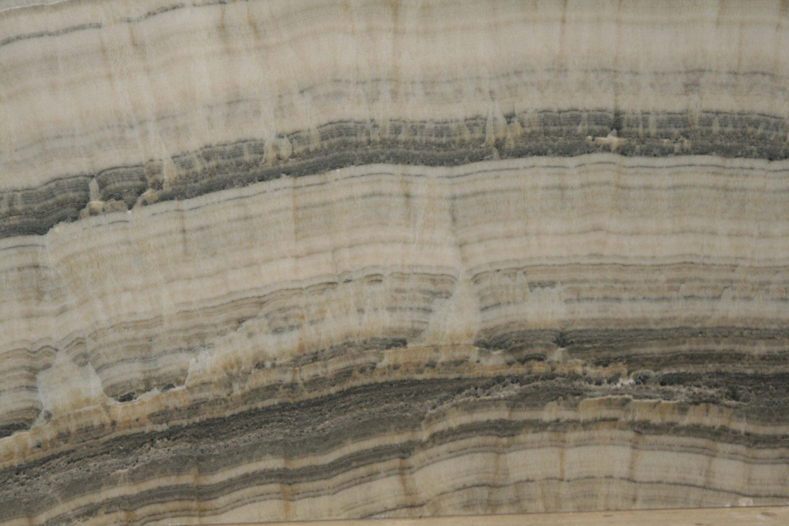 Onyx Grey Vein Cut countertops with layered charcoal and taupe banding for kitchen countertops. Onyx by Granite Guy Inc.