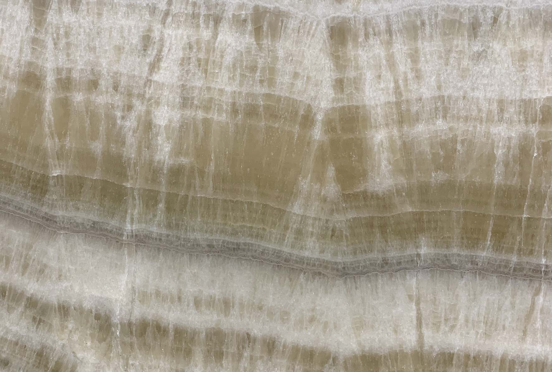 Onyx Honey countertops with golden amber tones and dramatic crystal texture for kitchen countertops. Onyx by Granite Guy Inc.