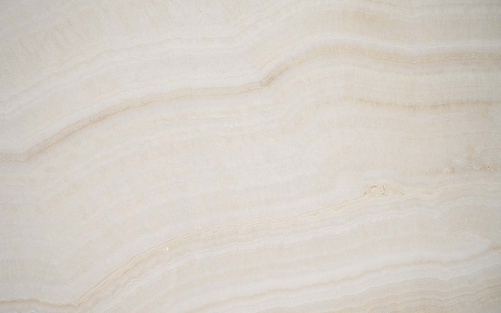 Onyx Ivory countertops with soft creamy layers and delicate veining for kitchen countertops. Onyx by Granite Guy Inc.