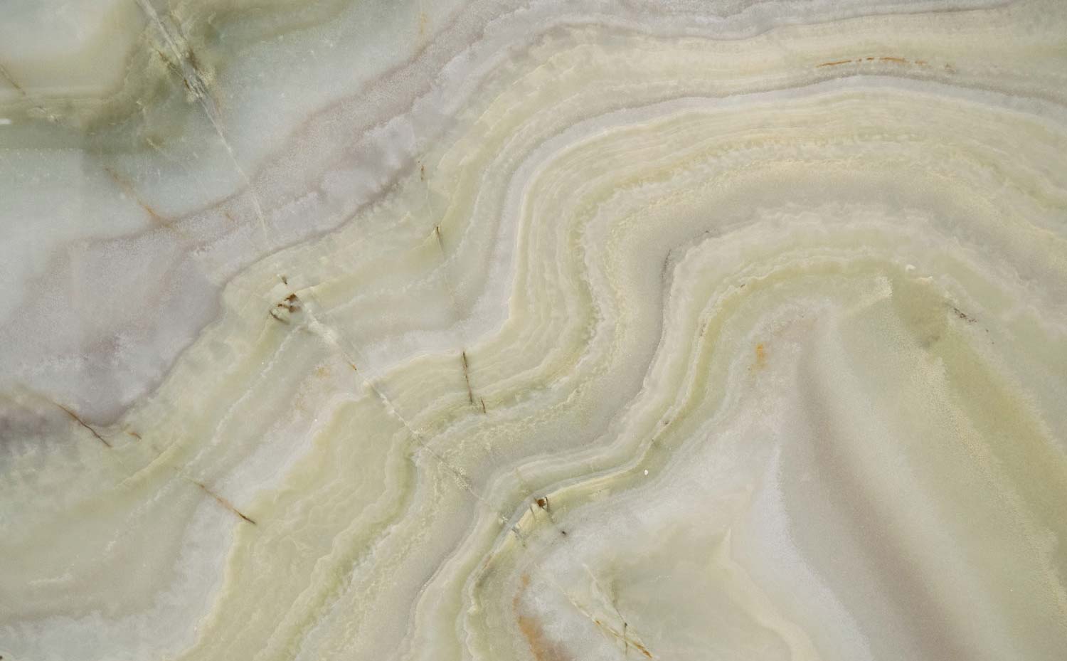Onyx Jade countertops with layered green, ivory, and lavender tones for kitchen countertops. Onyx by Granite Guy Inc.