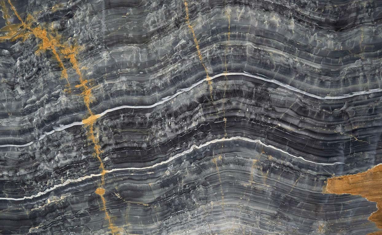 Onyx Nero countertops with bold black waves and striking gold veining for kitchen countertops. Onyx by Granite Guy Inc.