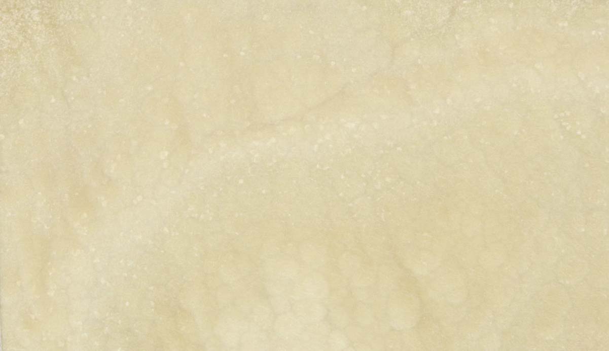 Onyx Sand Polished countertops with soft beige tones and a subtle cloudy texture for kitchen countertops. Onyx by Granite Guy Inc.