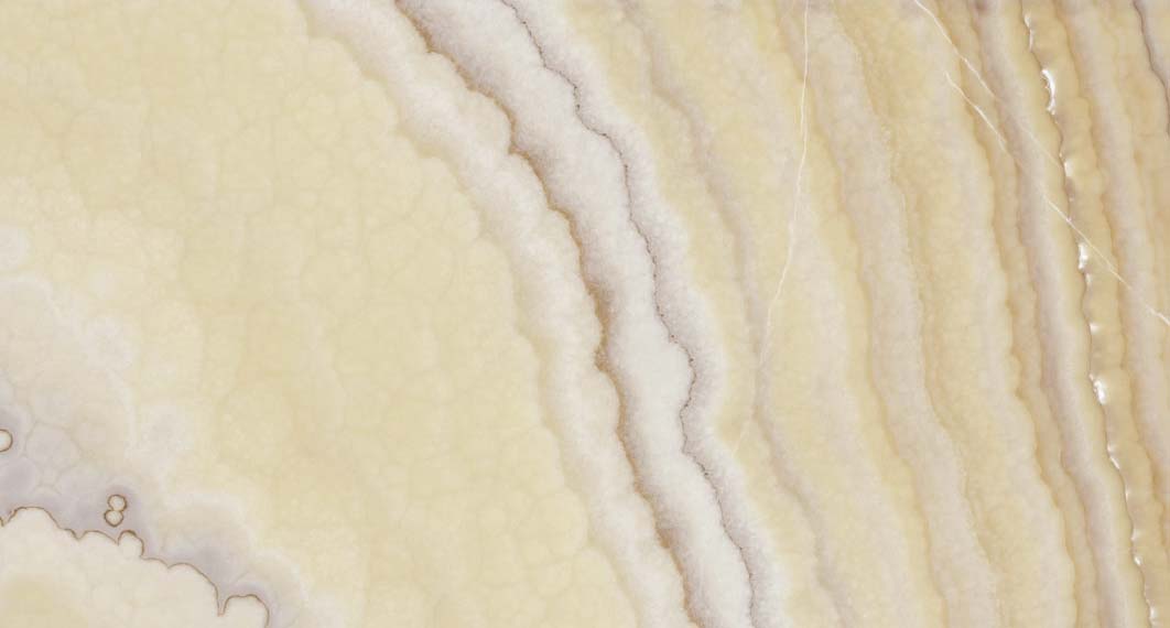 Onyx Sun Sole countertops with glowing honey tones and soft cream banding for kitchen countertops. Onyx by Granite Guy Inc.
