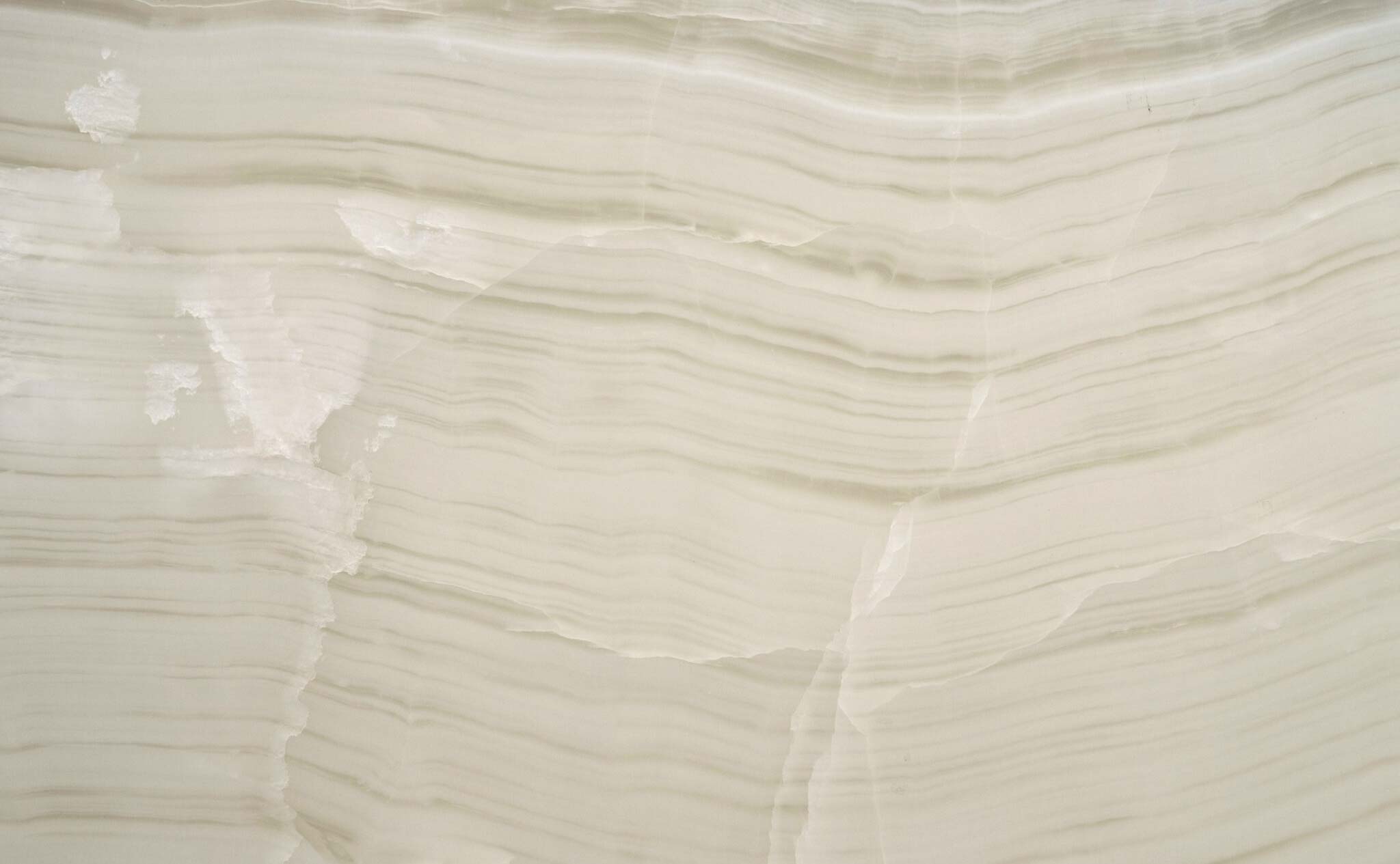 Onyx White Vein Cut countertops with soft linear banding for kitchen countertops. Onyx by Granite Guy Inc.