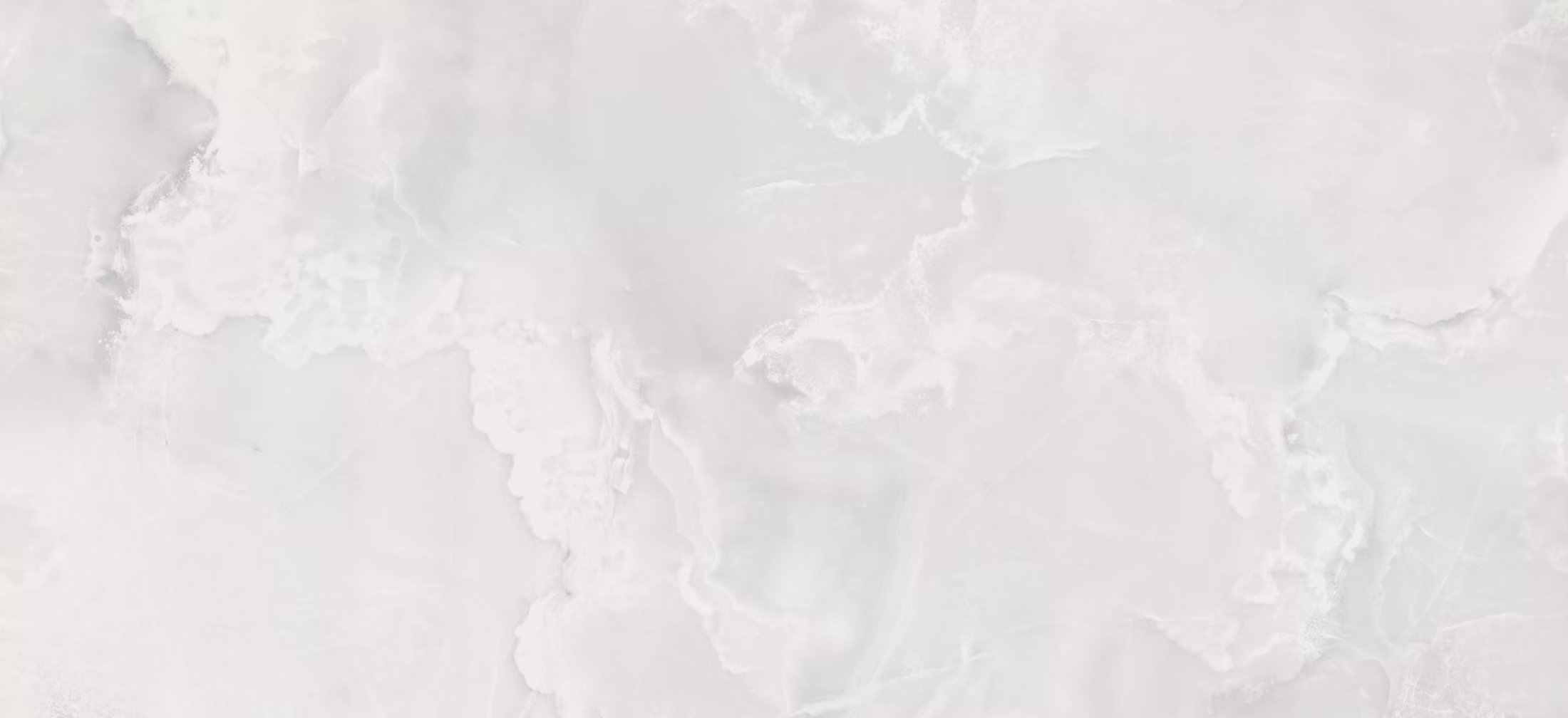 Dekton Helena porcelain kitchen countertops and shower walls with a soft cloudy white pattern and translucent look. Porcelain by Granite Guy Inc.
