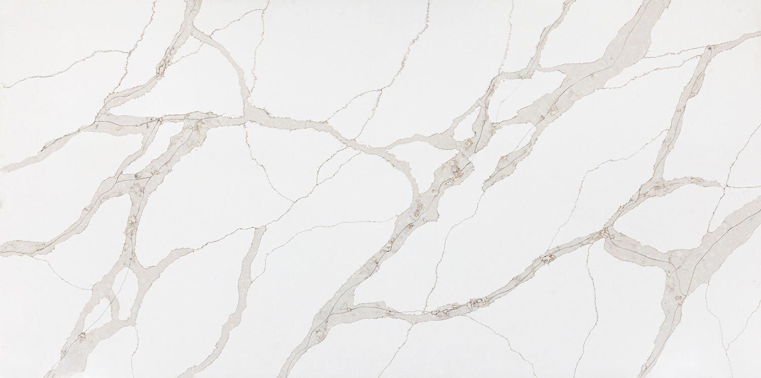 Vadara Quartz Aurum countertops with warm beige veining on white, perfect for kitchen countertops. Vadara quartz by Granite Guy Inc.