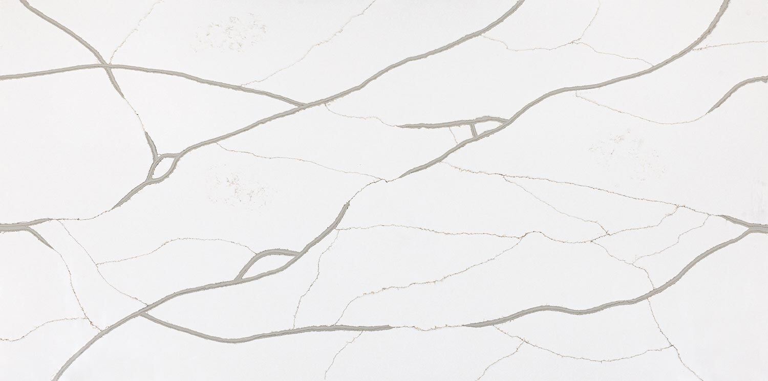 Vadara Quartz Calacatta Belleza countertops with bold taupe veining. Perfect for kitchen countertops. Vadara quartz by Granite Guy Inc.