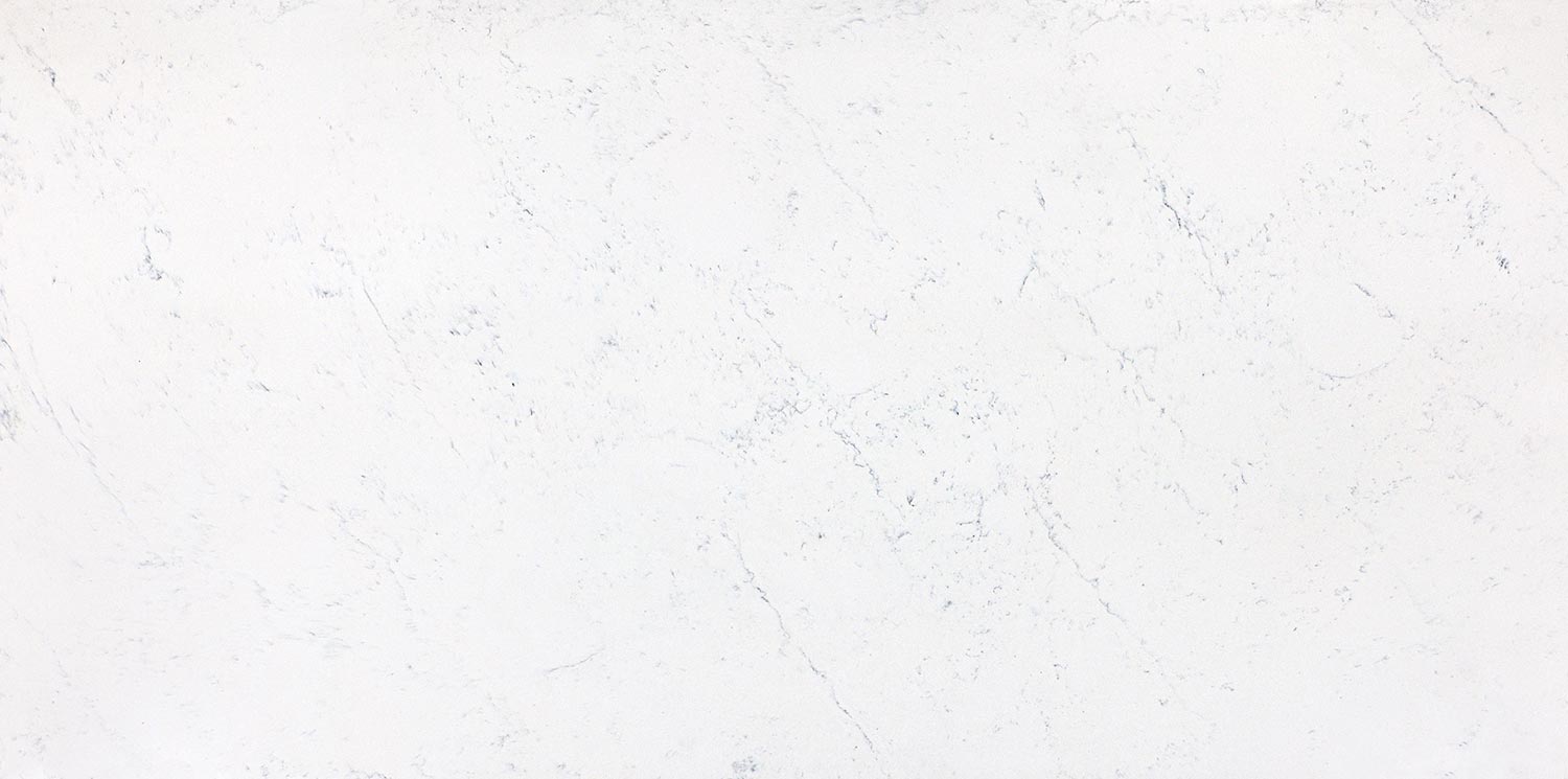 Vadara Quartz Carrara countertops with light marbled texture, ideal for kitchen countertops. Vadara quartz by Granite Guy Inc.