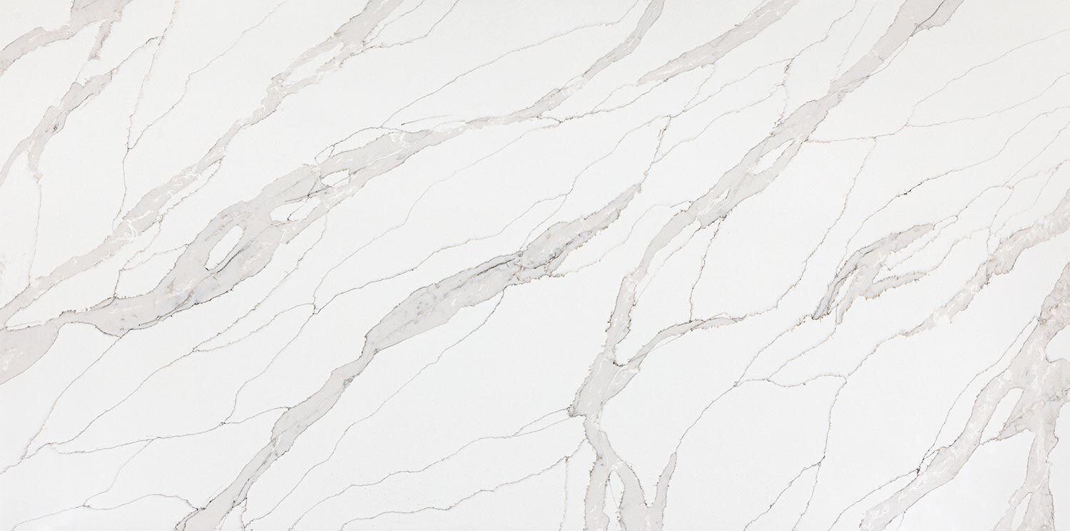 Vadara Quartz Cygnet Drift countertops with soft white base and flowing light gray veins. Kitchen countertops. Vadara quartz by Granite Guy Inc.