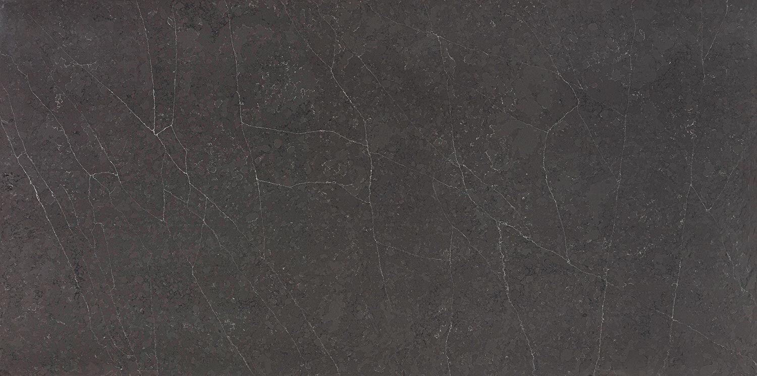 Vadara Quartz Petra Grigio countertops in a bold dark gray with subtle veining, ideal for kitchen countertops. Vadara quartz by Granite Guy Inc.