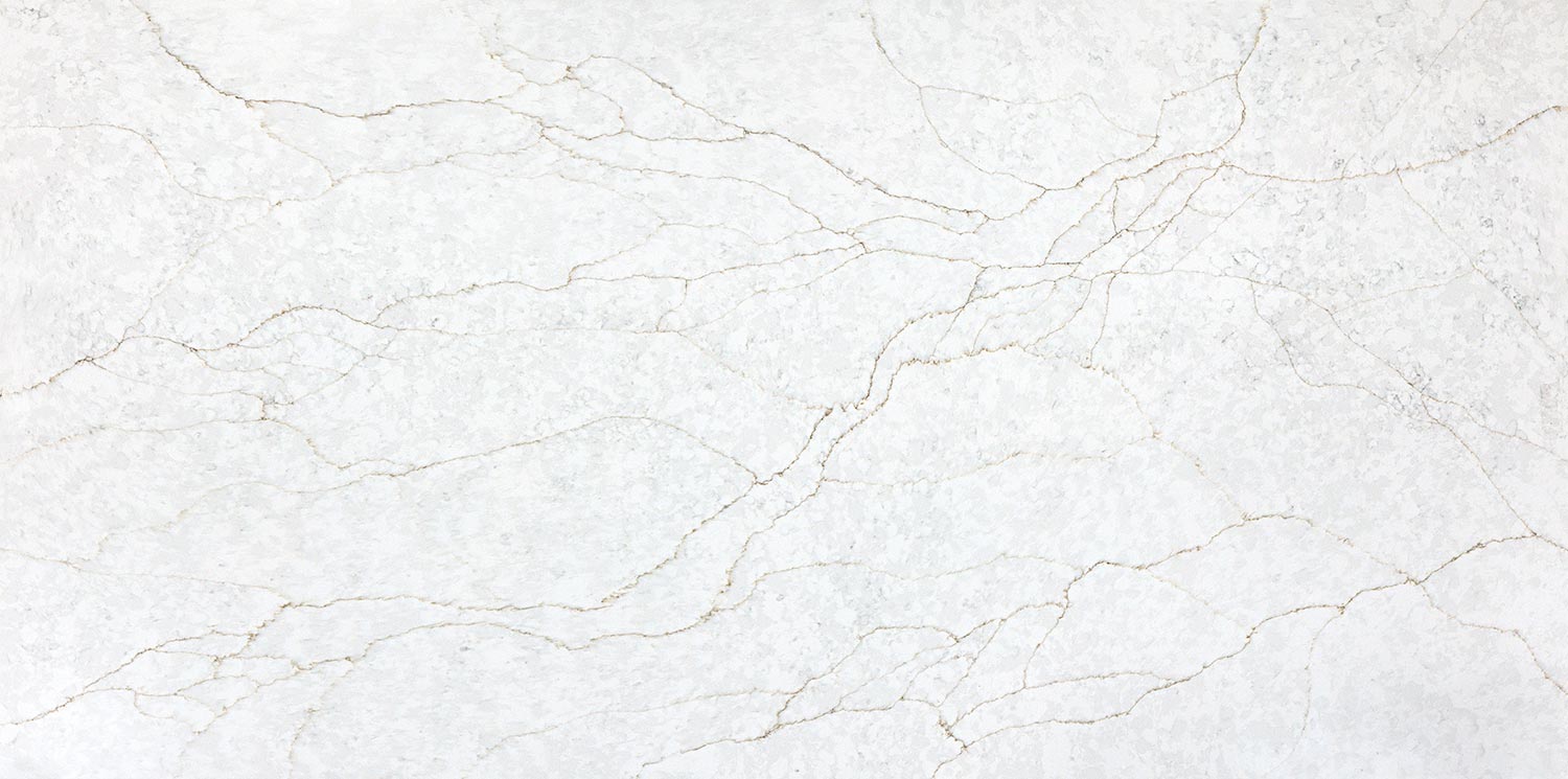 Vadara Quartz Sereno Gold countertops with a soft white background and fine gold-toned veining. Kitchen countertops. Vadara quartz by Granite Guy Inc.