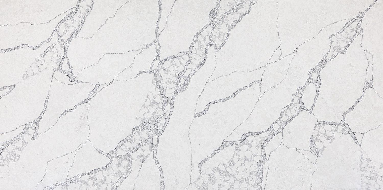 Vadara Quartz SkyDance countertops featuring delicate grey crackled veining on a soft white background, ideal for kitchen countertops. Vadara quartz by Granite Guy Inc.