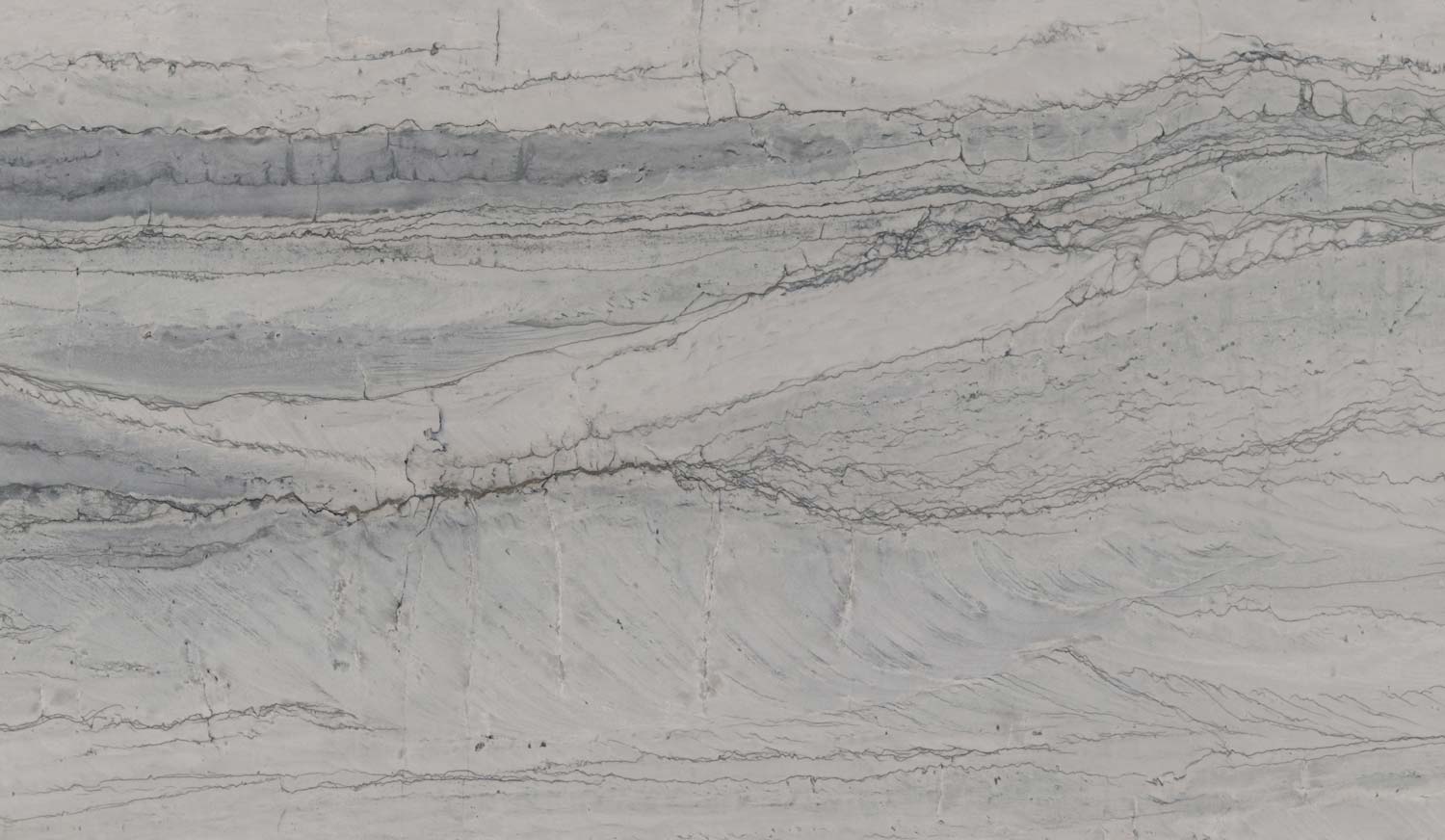 Maldives quartzite countertops with soft gray tones and flowing veins, perfect for kitchen countertops by Granite Guy Inc.