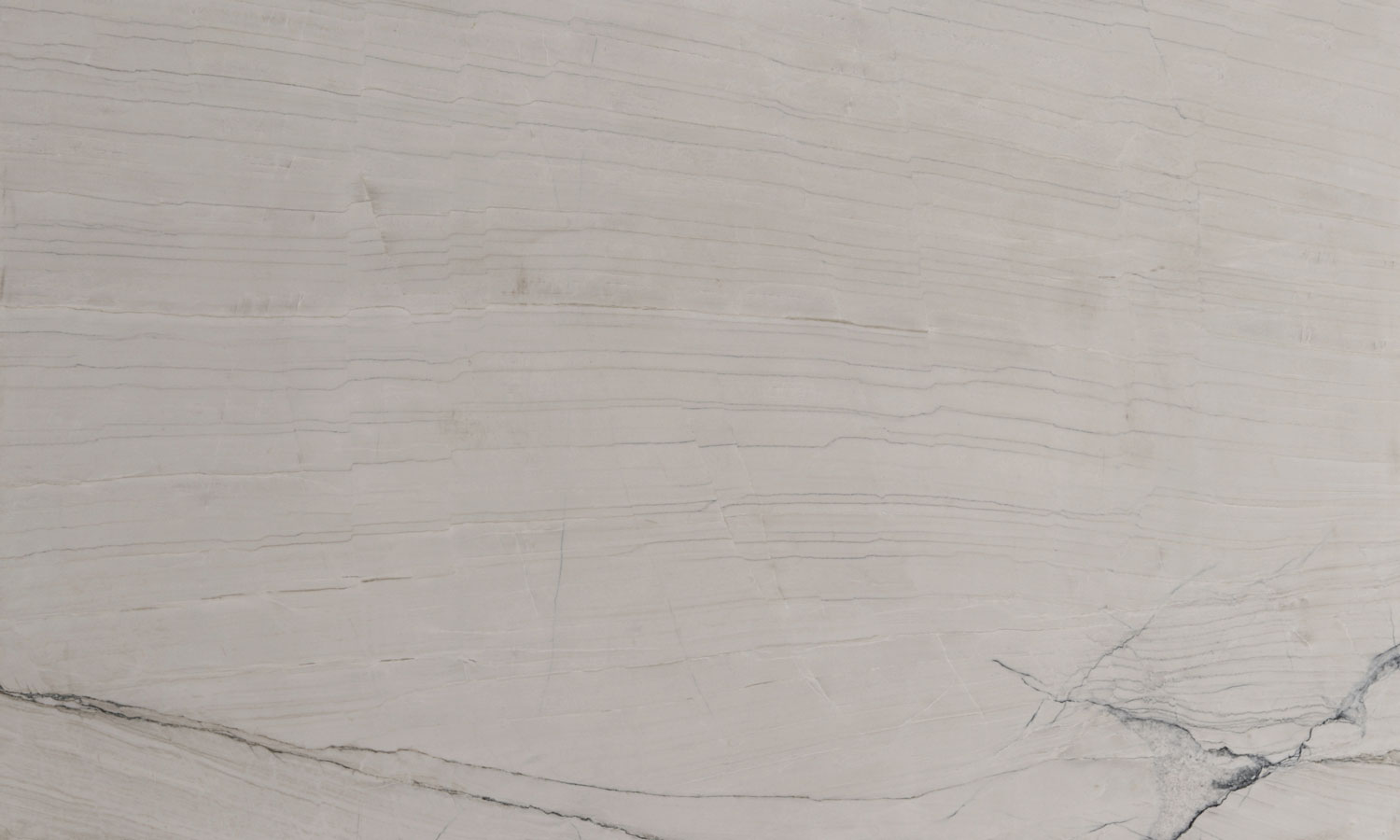 White Montreal quartzite countertops with soft linear patterns, perfect for kitchen countertops and vanities by Granite Guy Inc.