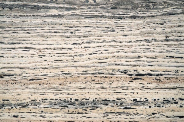 Travertine Platinum Black Label countertops with dramatic black and beige linear texture, ideal for kitchen countertops. Travertine by Granite Guy Inc.
