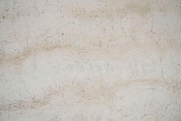 Travertine White Unfilled Leathered countertops with soft ivory layers and textured finish, great for kitchen countertops. Travertine by Granite Guy Inc.