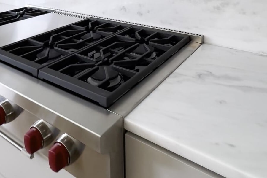 Appliance edge where a marble countertop meets the range in a MetroWest Massachusetts kitchen