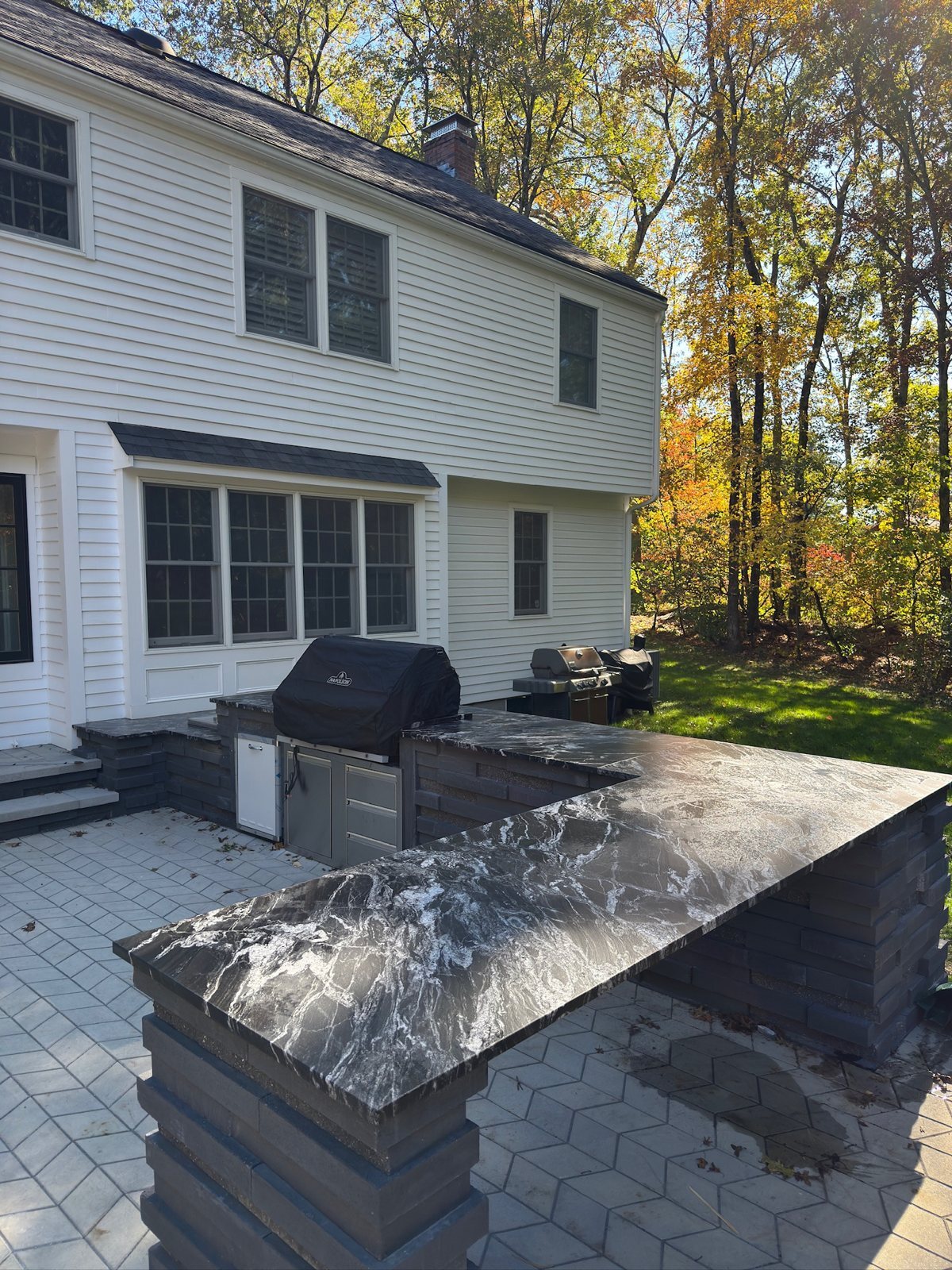 Black granite outdoor kitchen countertop on a patio in Sudbury, Massachusetts