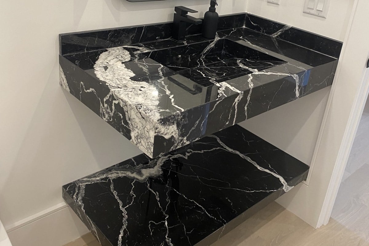 Mitered edge with eased corners on a Nero Marquina marble vanity with an integrated sink, Newton, MA