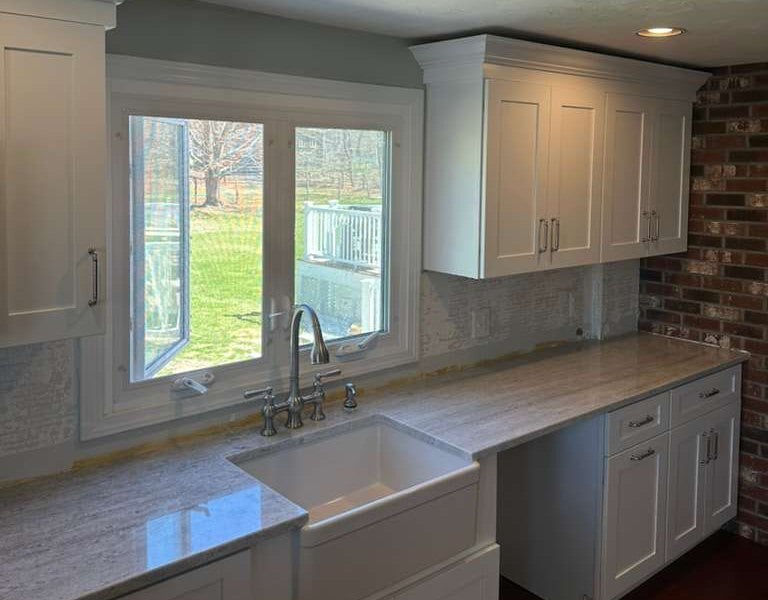 River White granite kitchen countertops with a farmhouse sink in a Massachusetts home