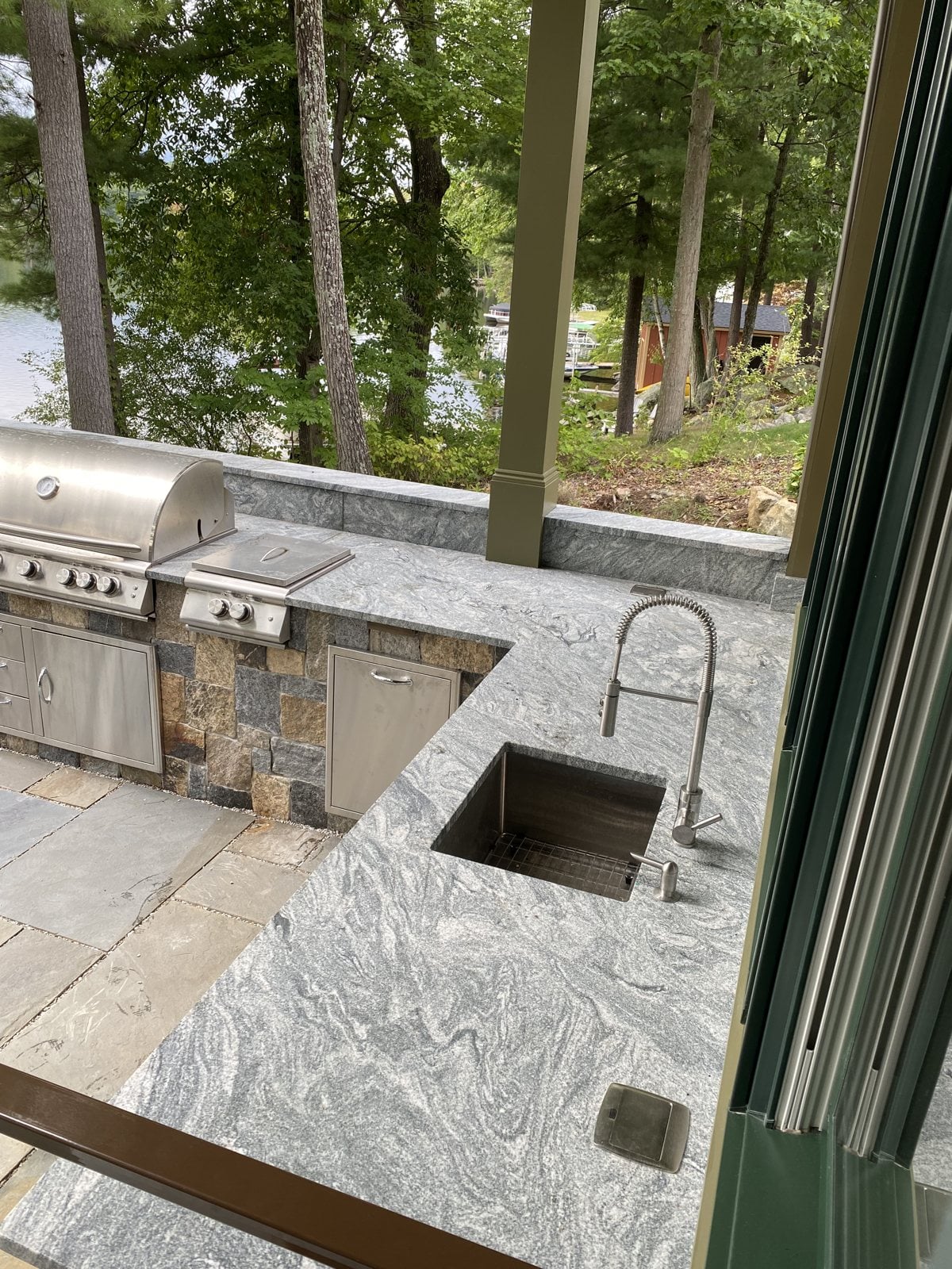 Silver Cloud leathered granite outdoor kitchen countertop with a sink in Hopkinton, Massachusetts