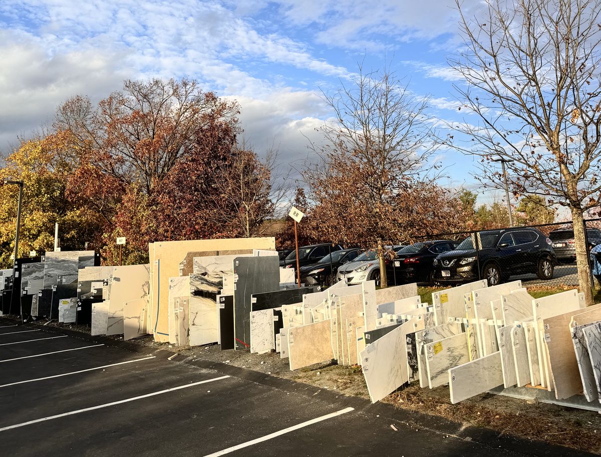 Stone remnants on the outdoor racks at the Granite Guy shop in Southborough, Massachusetts