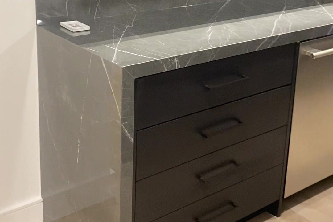Waterfall countertop end in porcelain with an eased joint, Newton, Massachusetts